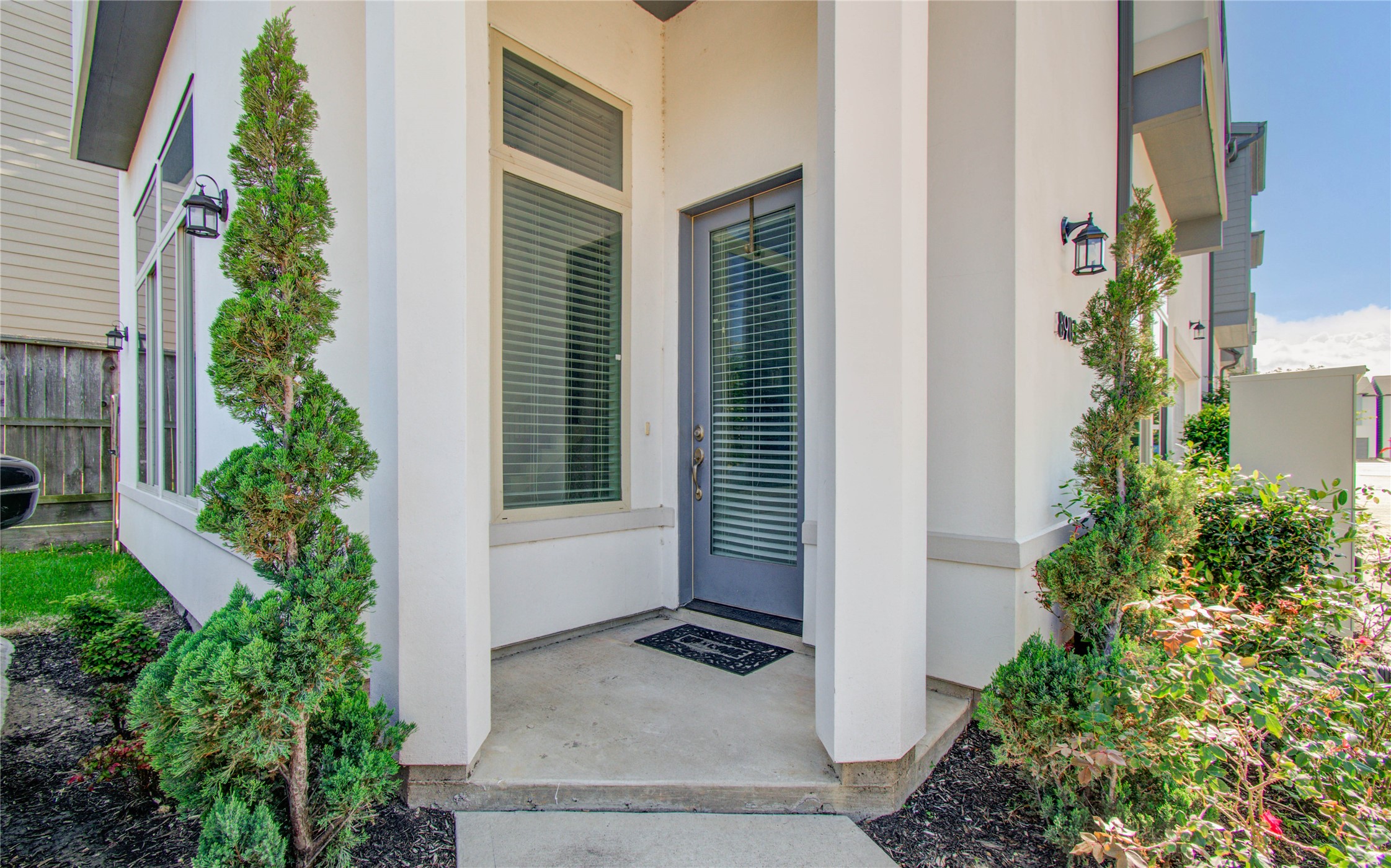 8903 Spring Knoll Forest Drive Houston, TX 77080 - Photo 2 of 29 front view of house with potted plants next to a small yard