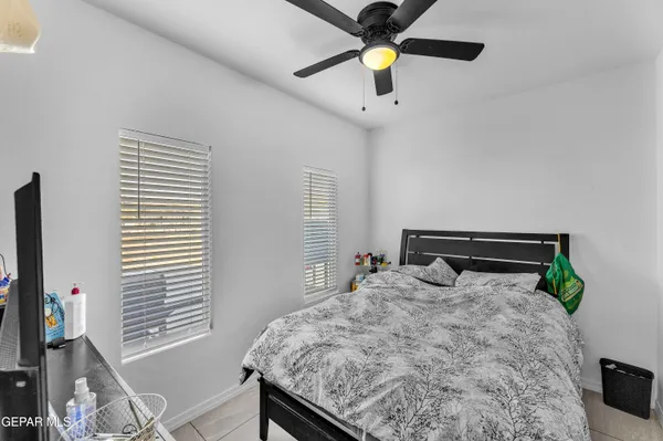 a living room with furniture kitchen view and a chandelier