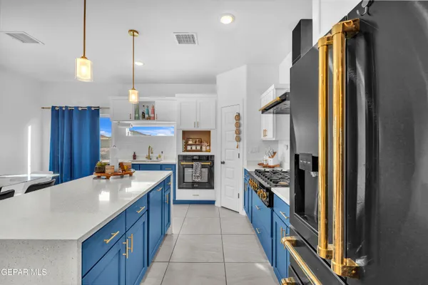 a kitchen with stainless steel appliances granite countertop a stove and a microwave