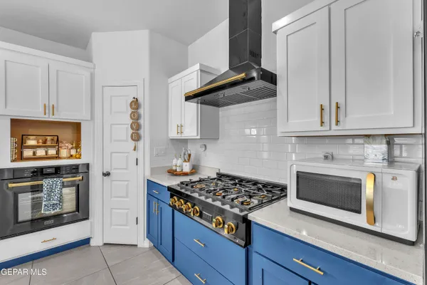 a large kitchen with kitchen island a stove a sink a table and chairs