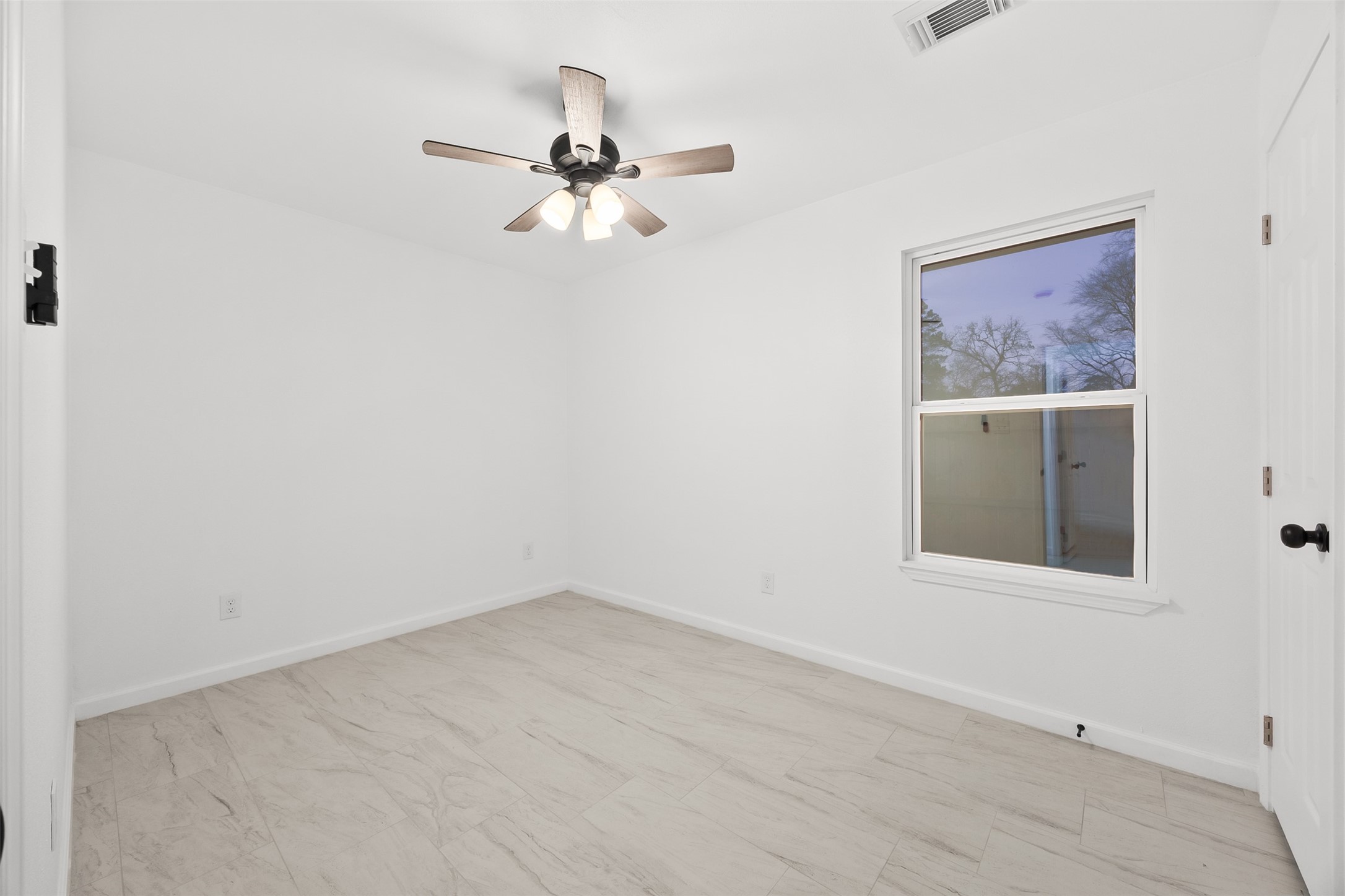 22101 Diane Drive Spring, TX 77373 - Photo 17 of 24 an empty room with a window and a fan