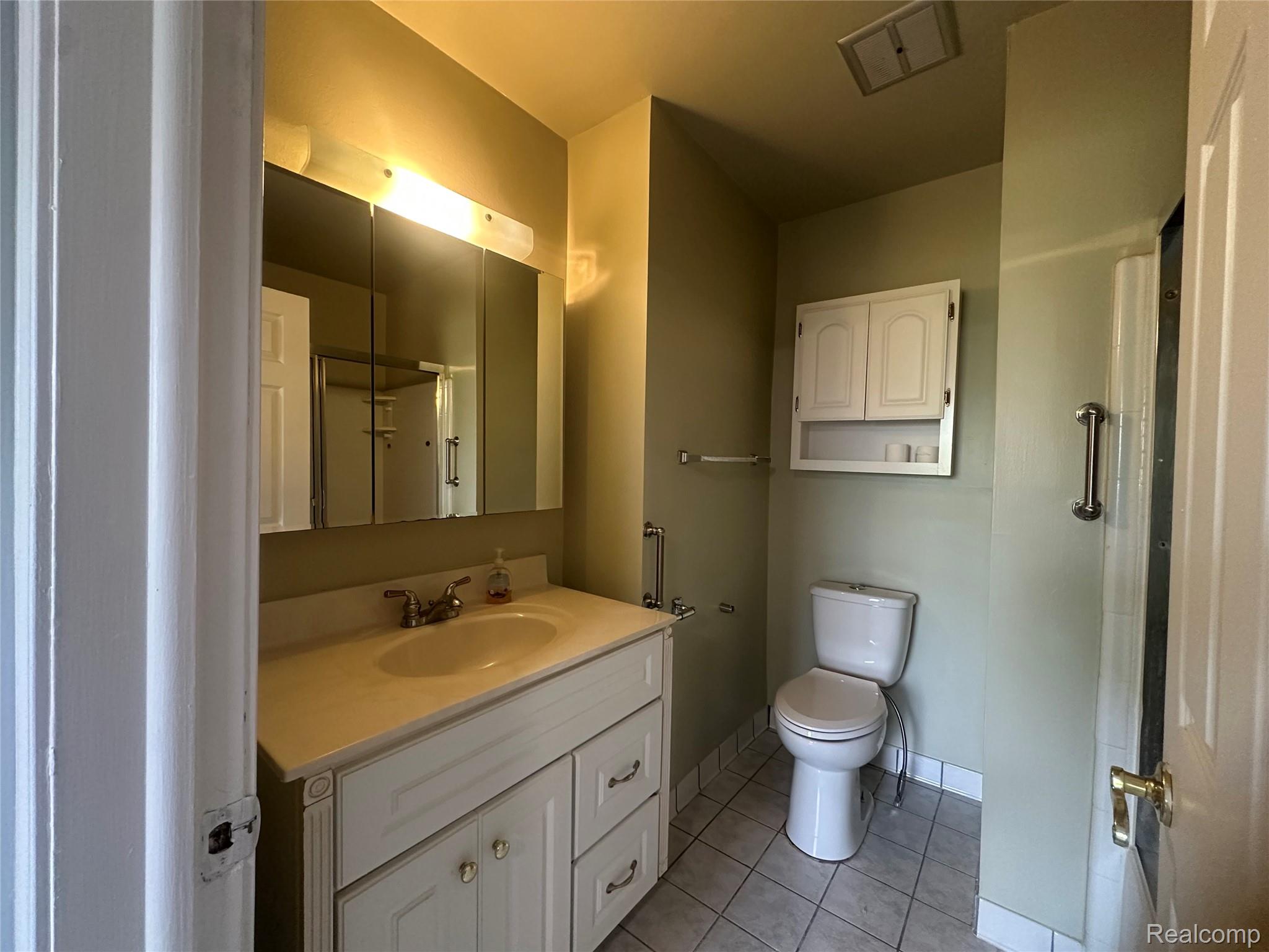509 East University Drive Rochester, MI 48307 - Photo 12 of 20 Full bathroom featuring a shower with curtain, vanity, and light tile patterned floors