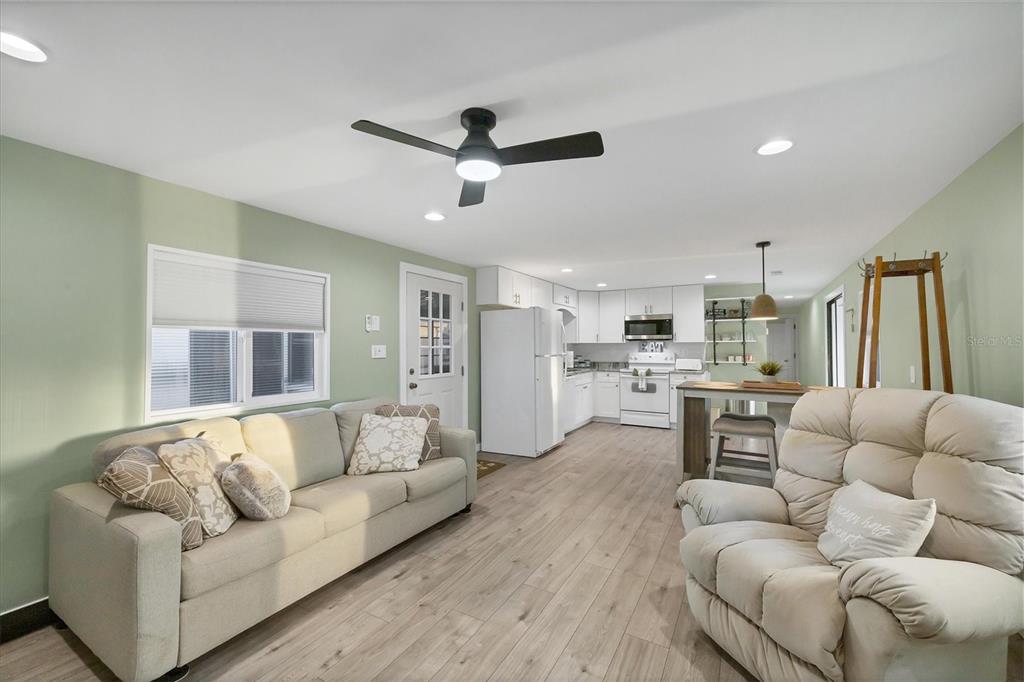 1891 Englewood Road, Unit 1 Englewood, FL 34223 - Photo 12 of 46 a living room with furniture and kitchen view