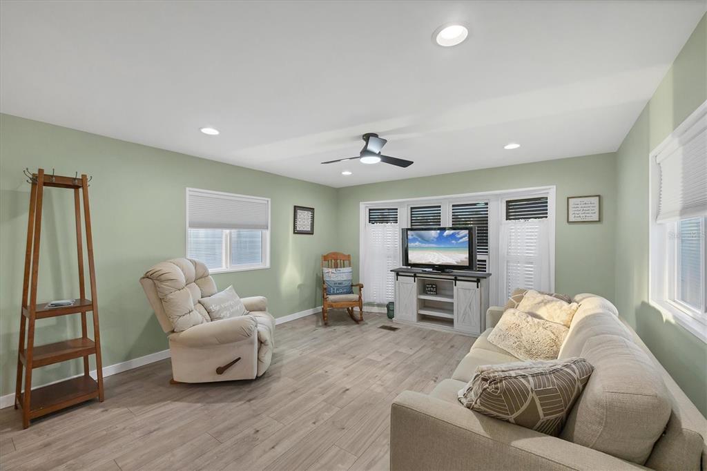 1891 Englewood Road, Unit 1 Englewood, FL 34223 - Photo 2 of 46 a living room with furniture and a flat screen tv