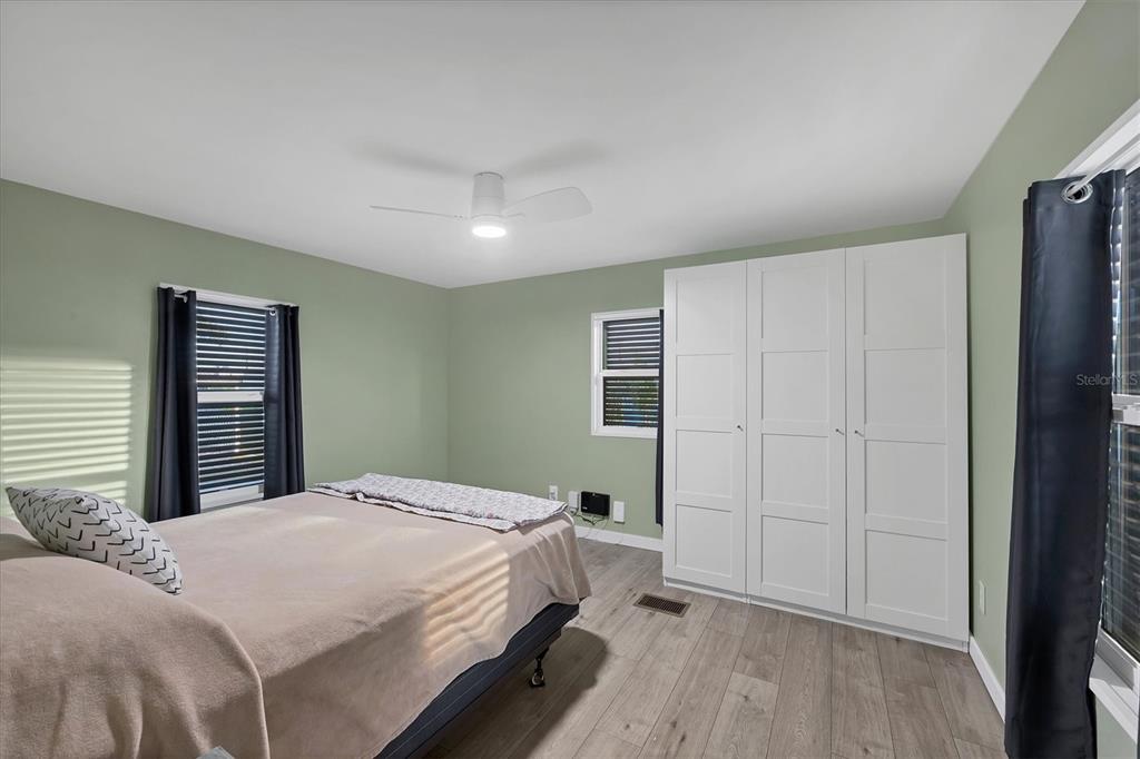 1891 Englewood Road, Unit 1 Englewood, FL 34223 - Photo 21 of 46 a bed room with a bed and a closet