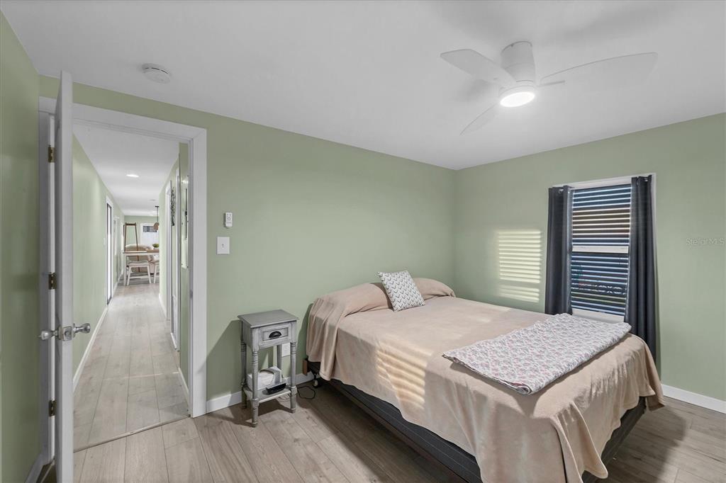1891 Englewood Road, Unit 1 Englewood, FL 34223 - Photo 22 of 46 a bedroom with a bed and a table in it