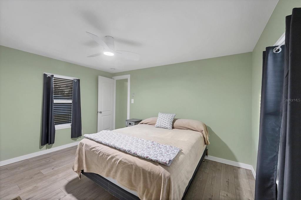 1891 Englewood Road, Unit 1 Englewood, FL 34223 - Photo 23 of 46 a bedroom with a bed and a table