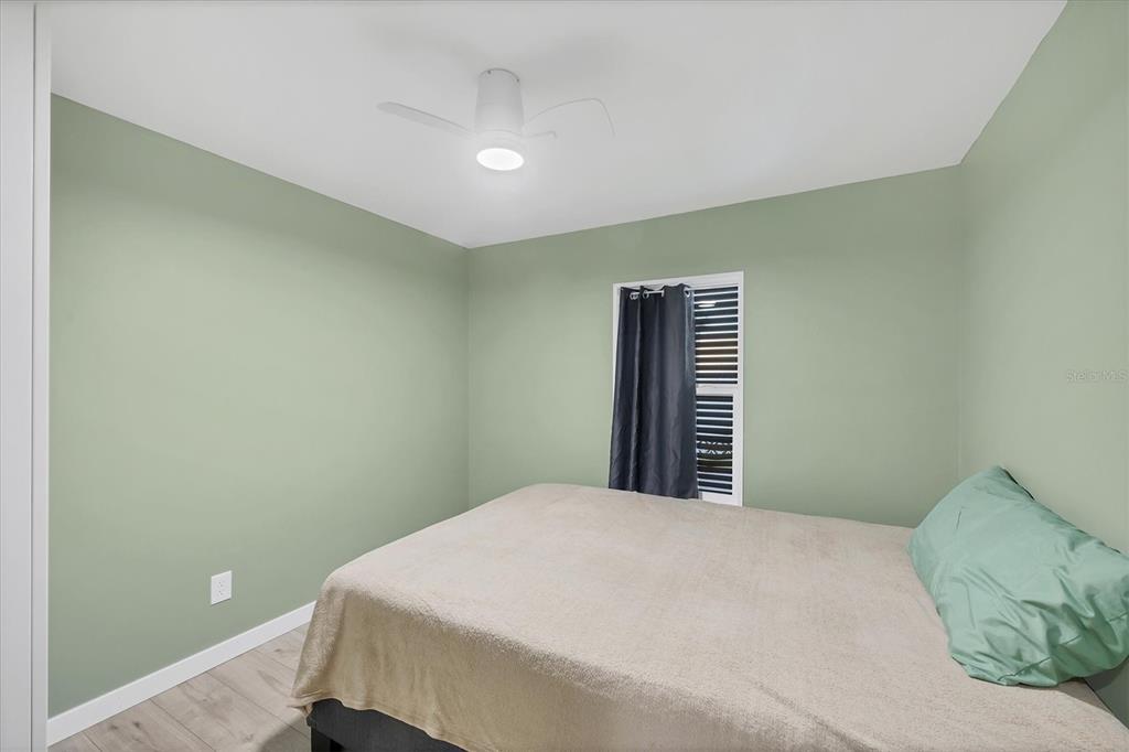 1891 Englewood Road, Unit 1 Englewood, FL 34223 - Photo 25 of 46 a bedroom with a bed and a painting on the wall