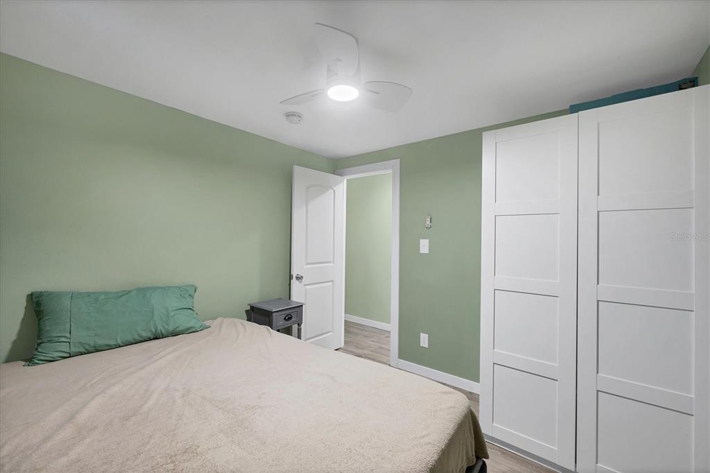 1891 Englewood Road, Unit 1 Englewood, FL 34223 - Photo 26 of 46 a bedroom with a bed and cabinets
