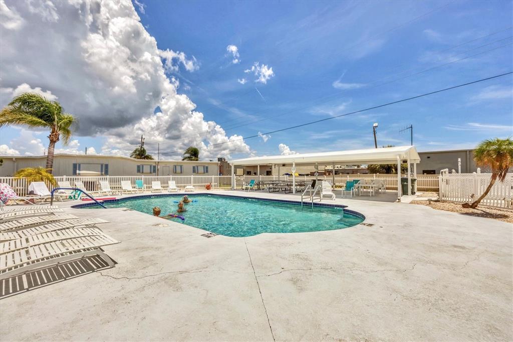 1891 Englewood Road, Unit 1 Englewood, FL 34223 - Photo 39 of 46 a view of a swimming pool with a patio