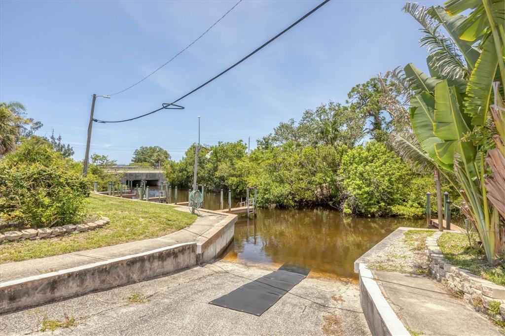 1891 Englewood Road, Unit 1 Englewood, FL 34223 - Photo 43 of 46 a view of a lake with a house
