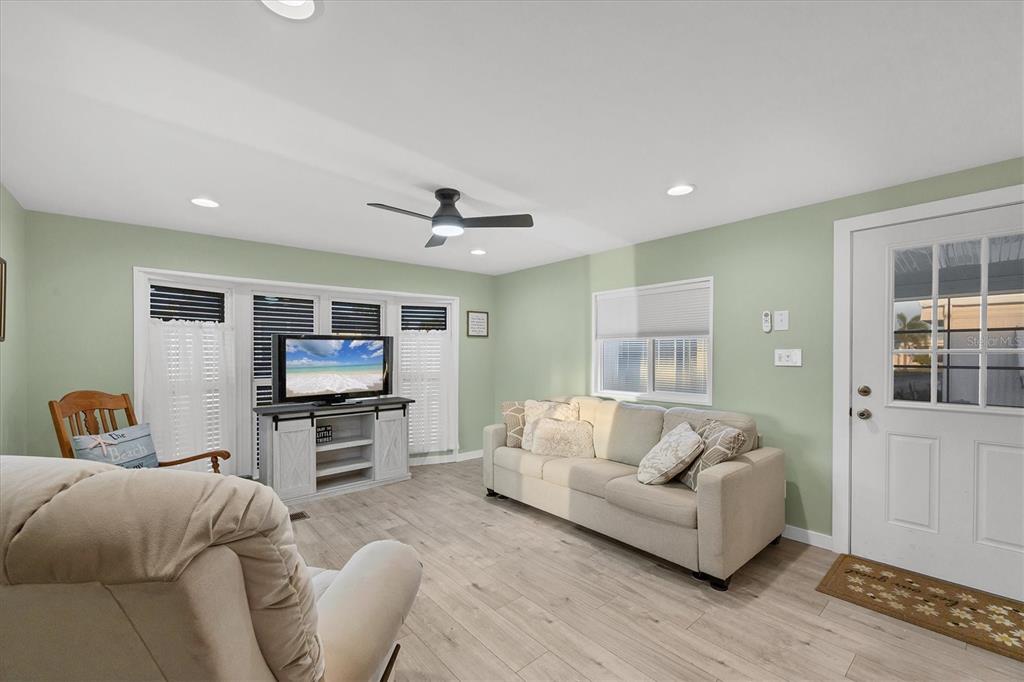 1891 Englewood Road, Unit 1 Englewood, FL 34223 - Photo 9 of 46 a living room with furniture and a flat screen tv