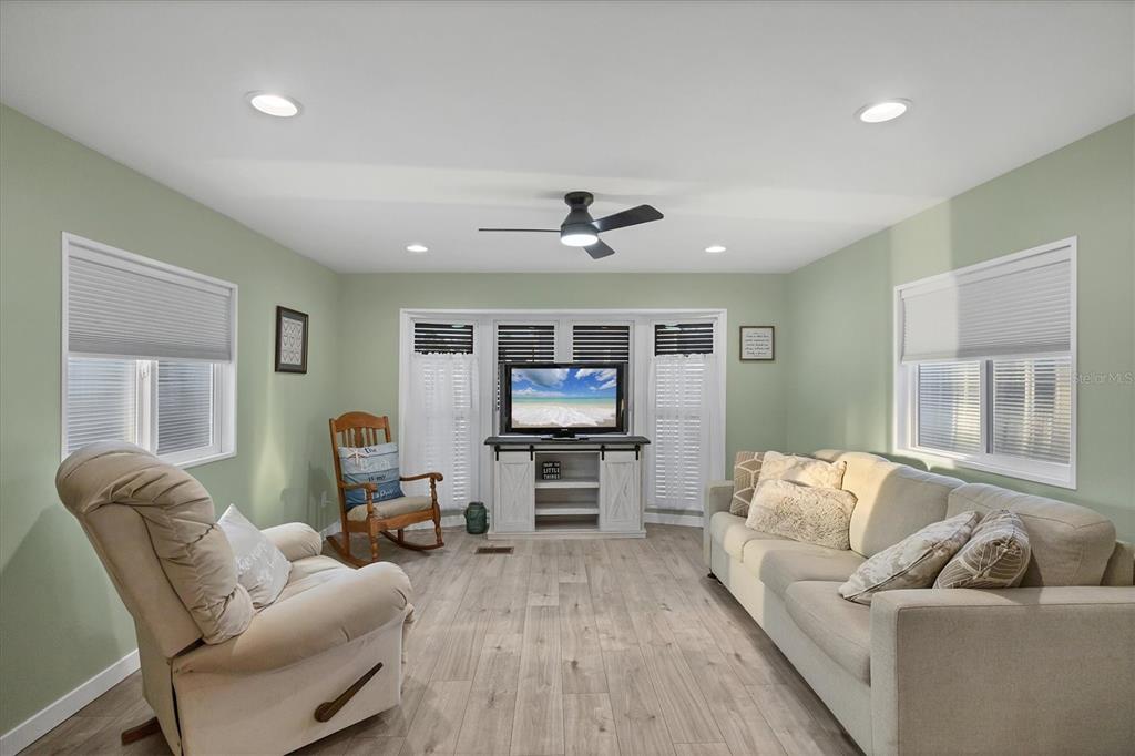 1891 Englewood Road, Unit 1 Englewood, FL 34223 - Photo 10 of 46 a living room with furniture and a flat screen tv