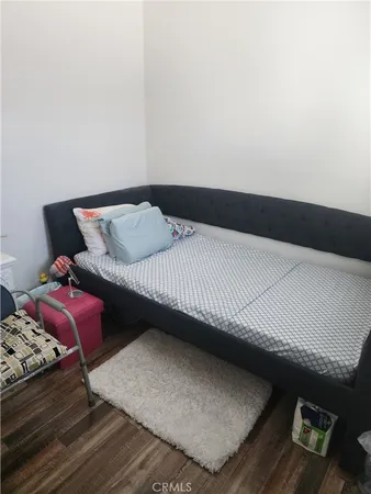 a bedroom with a bed and a night stand
