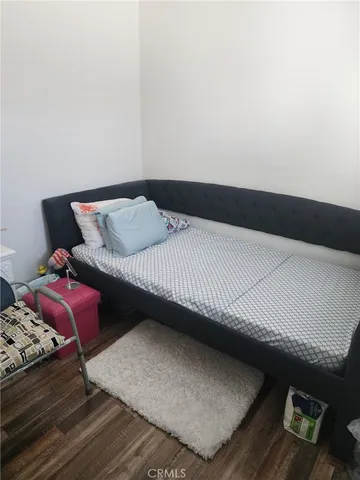 a bedroom with a bed and a night stand