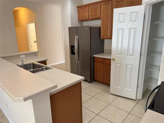 a kitchen with stainless steel appliances a refrigerator and a stove