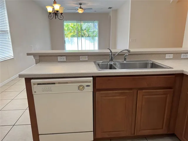 a view of a sink a mirror and cabinets