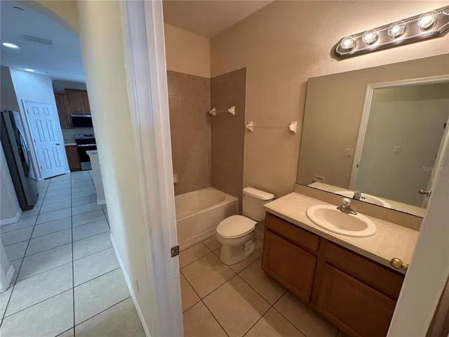 a bathroom with a double vanity sink toilet and shower
