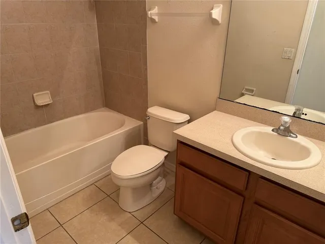 a bathroom with a sink a toilet and bathtub
