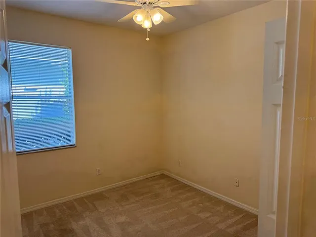 a view of a small space with wooden floor and a window