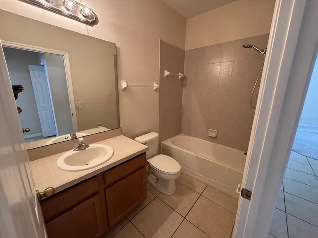 a bathroom with a sink a toilet a mirror and shower