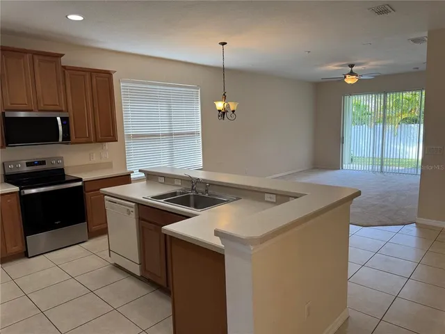 a kitchen that has a sink and a stove in it