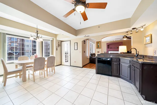 a view of kitchen with granite countertop cabinets table and chairs