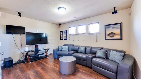a view of a hallway with wooden floor and stairs