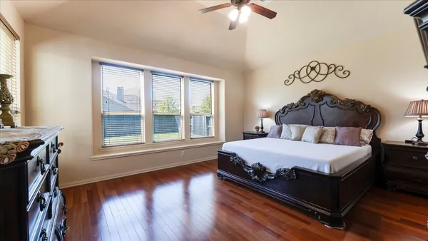 a bedroom with a bed and a dresser