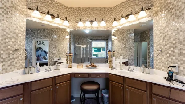 a bathroom with a tub a sink and glass door