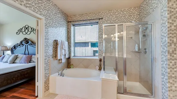 a large bathroom with a sink a large mirror and a bathtub