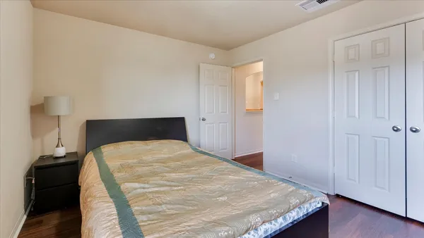 a patio with glass top table and chairs