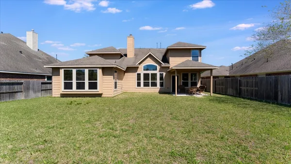 a view of a house with a yard and potted plants