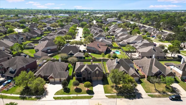 an aerial view of a house with outdoor space and a lake view