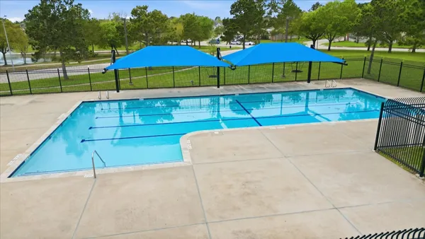 an aerial view of a house with a garden and swimming pool