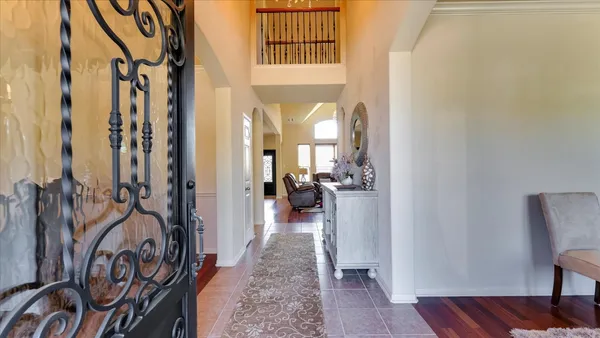 a view of a hallway to a livingroom with furniture