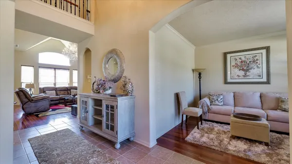 a living room with furniture a fireplace and a large window