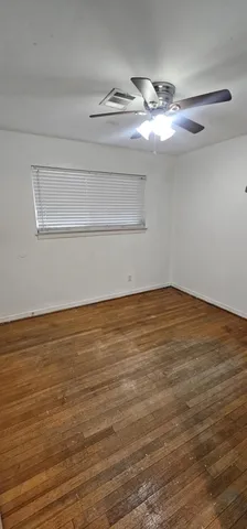 a view of a room with wooden floor and staircase