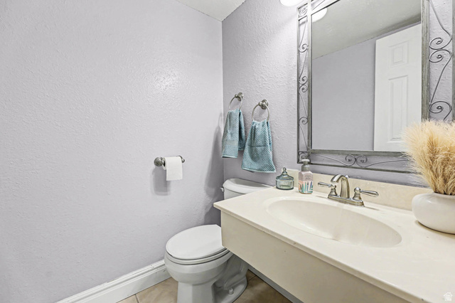 34 Benchmark Village Tooele, UT 84074 - Photo 12 of 35 Half bathroom featuring a textured wall and vanity