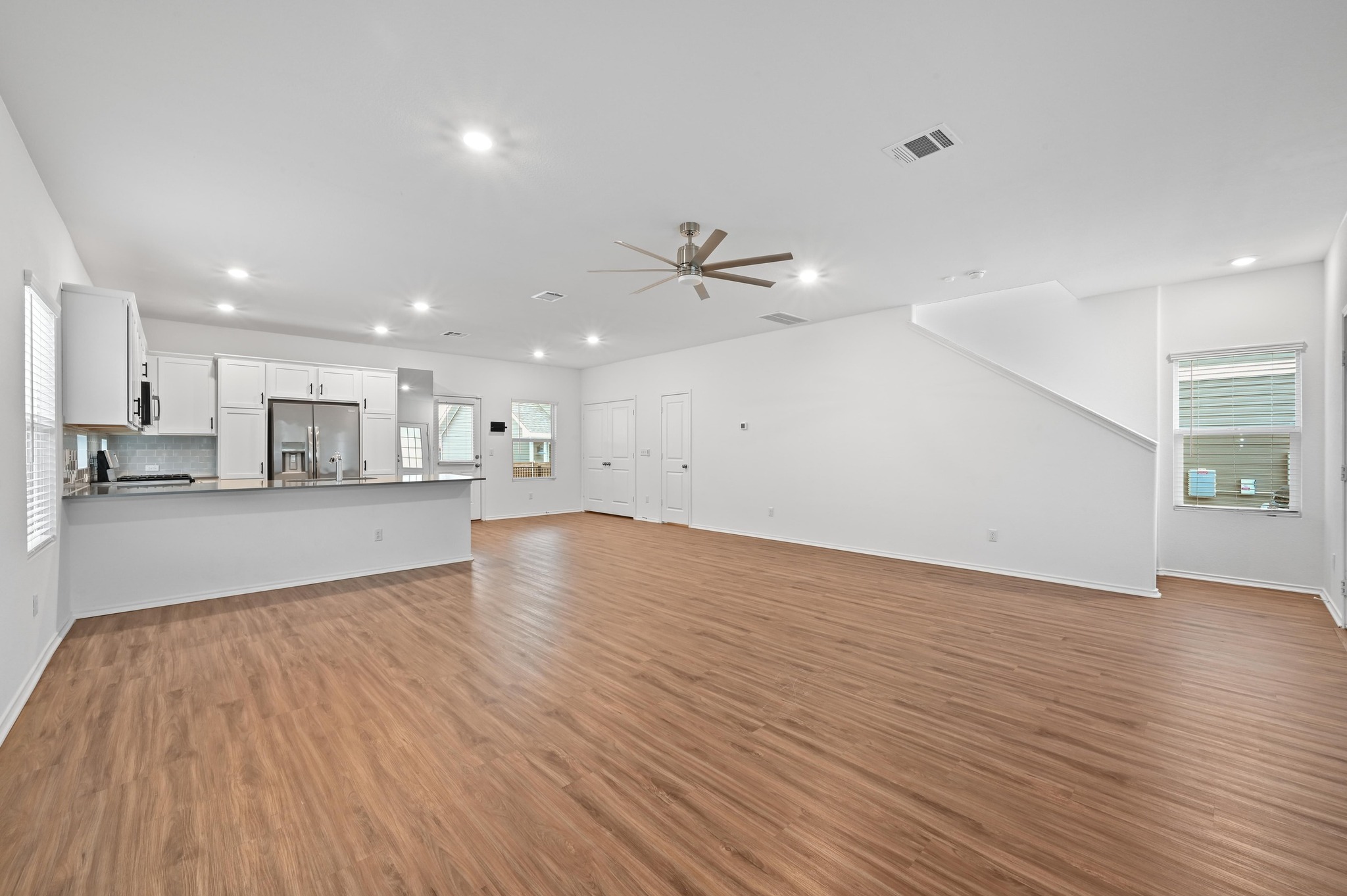 167 Rioja, Unit MAIN HOUSE) Kyle, TX 78640 - Photo 6 of 26 Unfurnished living room with recessed lighting, light wood finished floors, and a ceiling fan