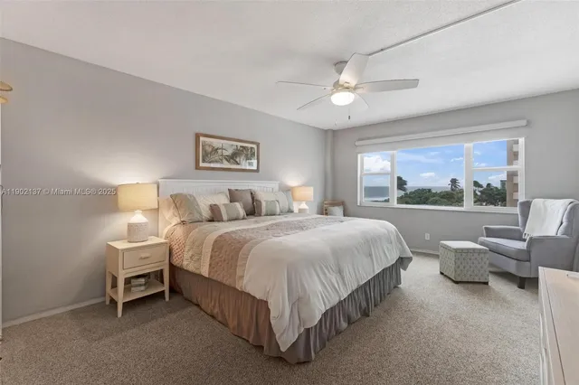 a spacious bedroom with a bed and a large window