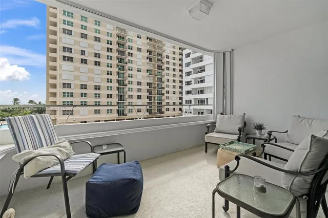 a reading room with furniture and a large window