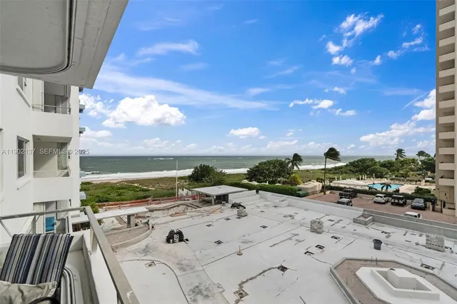 a view of a terrace with lawn chairs