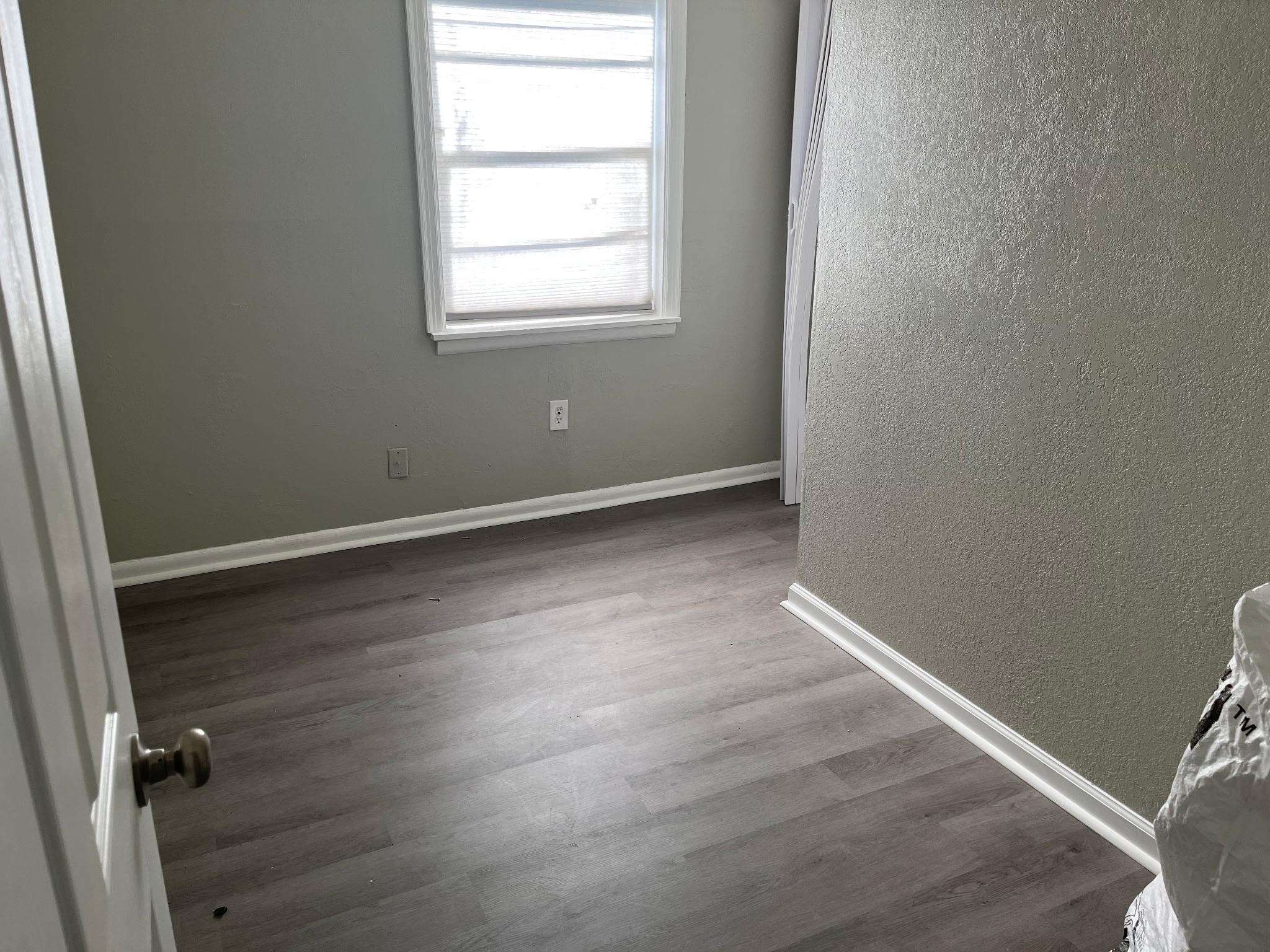 518 Harahan Road Memphis, TN 38109 - Photo 4 of 9 Empty room with a textured wall and dark wood finished floors