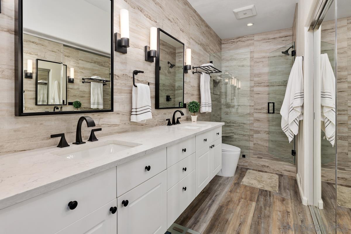 a bathroom with double vanity sink and a mirror