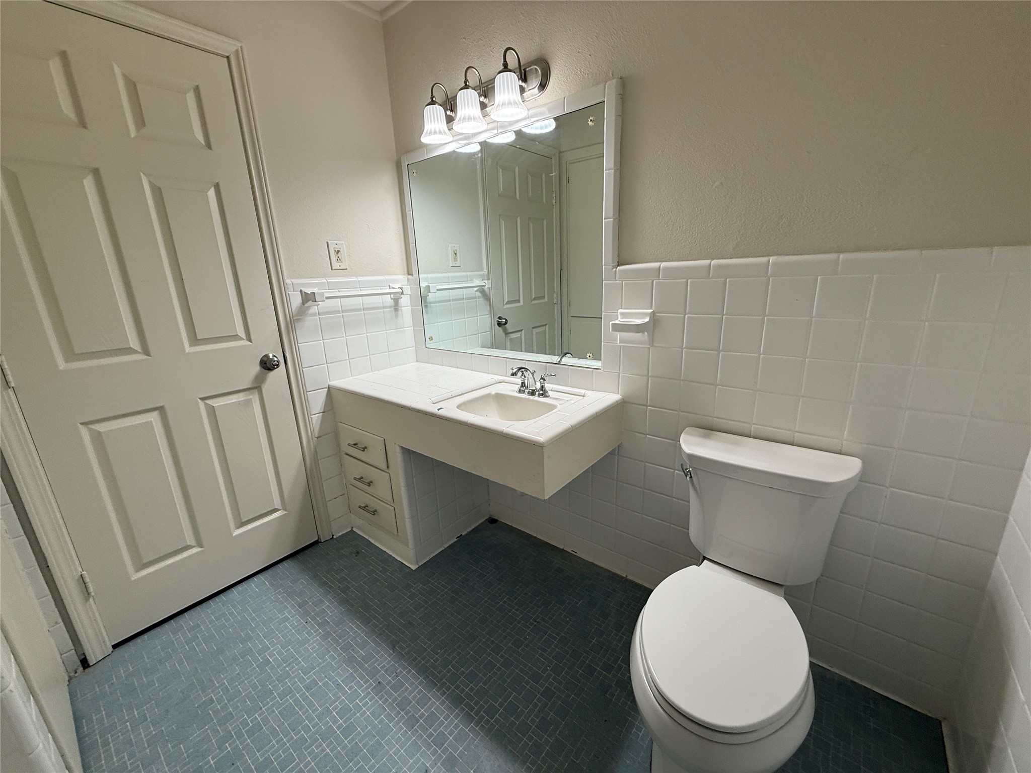 2310 Pecos La Marque, TX 77568 - Photo 17 of 26 a bathroom with a toilet sink and mirror