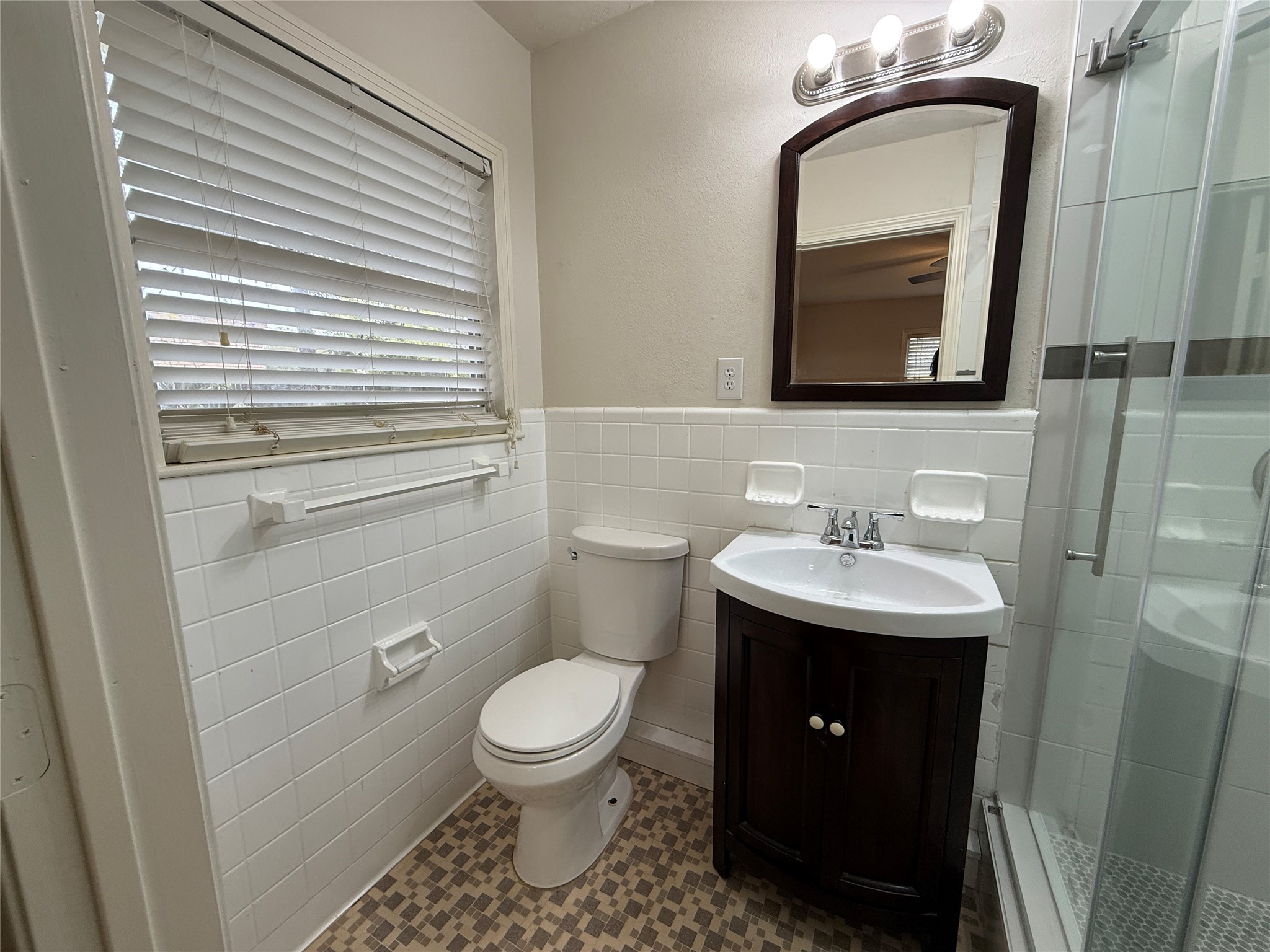 2310 Pecos La Marque, TX 77568 - Photo 22 of 26 a bathroom with a toilet a sink a vanity and mirror