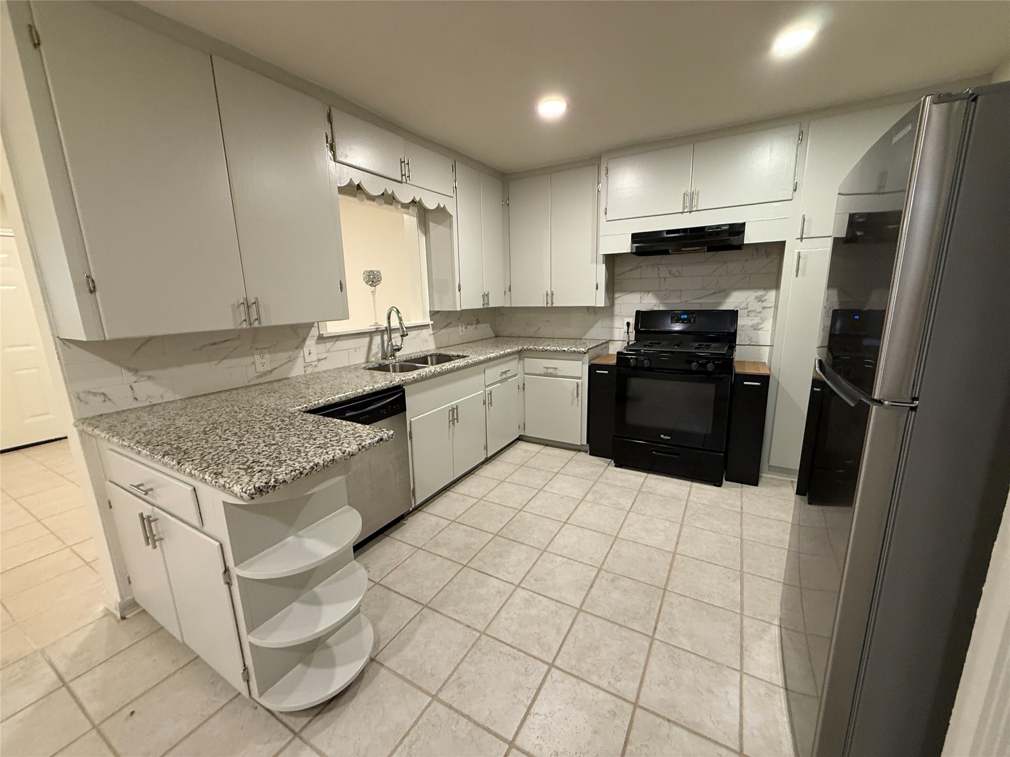 2310 Pecos La Marque, TX 77568 - Photo 7 of 26 a kitchen with stainless steel appliances granite countertop a sink stove and refrigerator