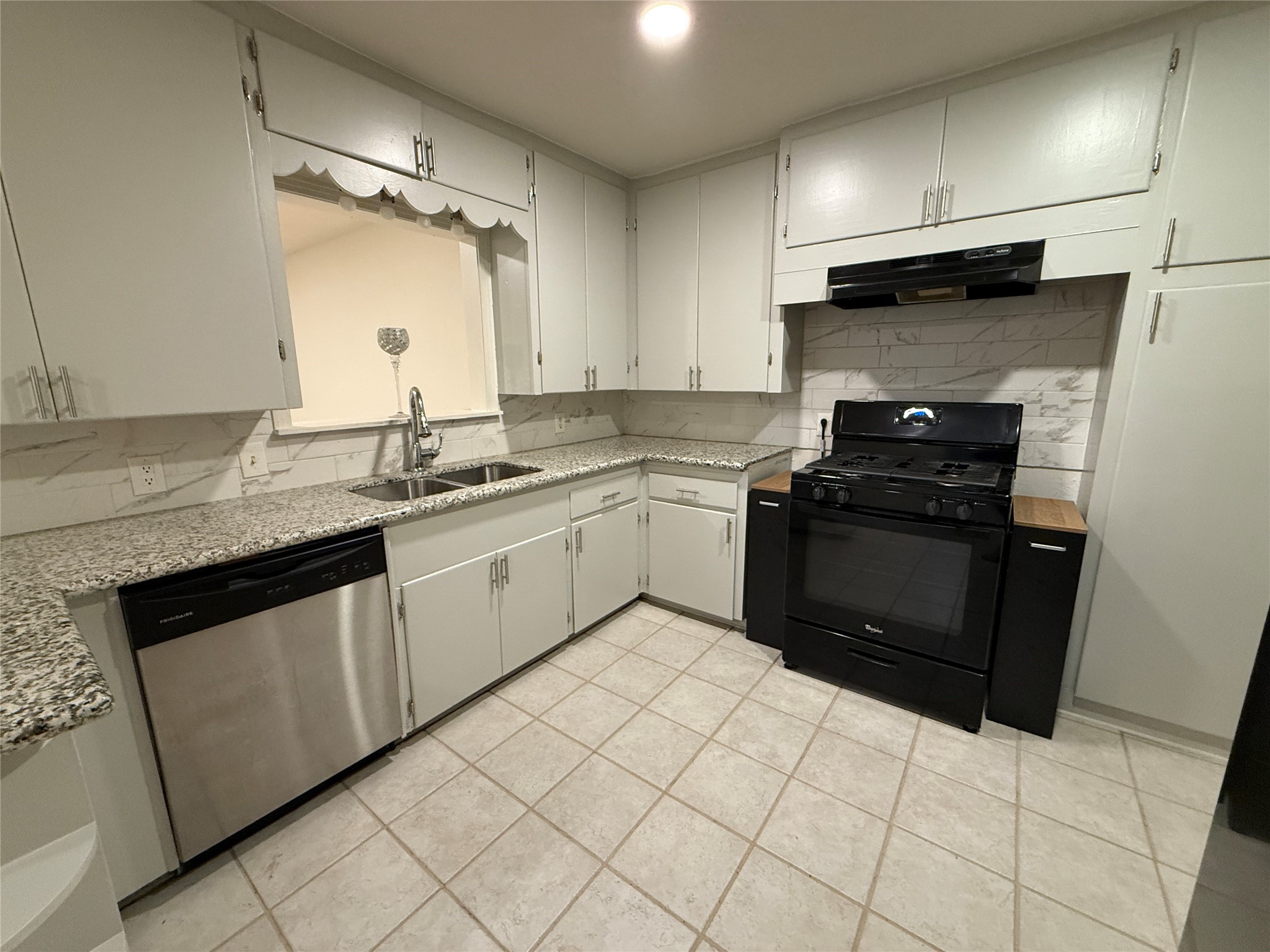 2310 Pecos La Marque, TX 77568 - Photo 8 of 26 a kitchen with a sink a stove and refrigerator