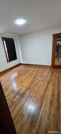 a view of an empty room and wooden floor